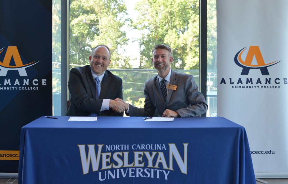 President Dr. Ingle shaking hands with the President of NC Wesleyan University after the articulation agreement signing