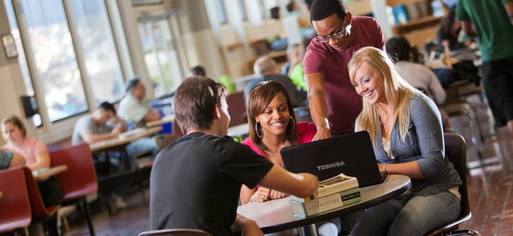 students sitting around table on campus