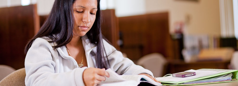 Female student reading in classroom